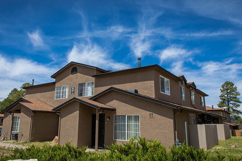 a large house with a blue sky in the background