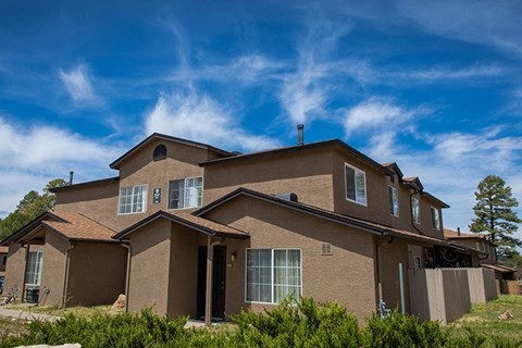 a large house with a blue sky in the background