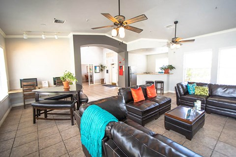 a living room with leather couches and a table