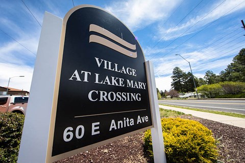 a sign for the village at lake marina crossing