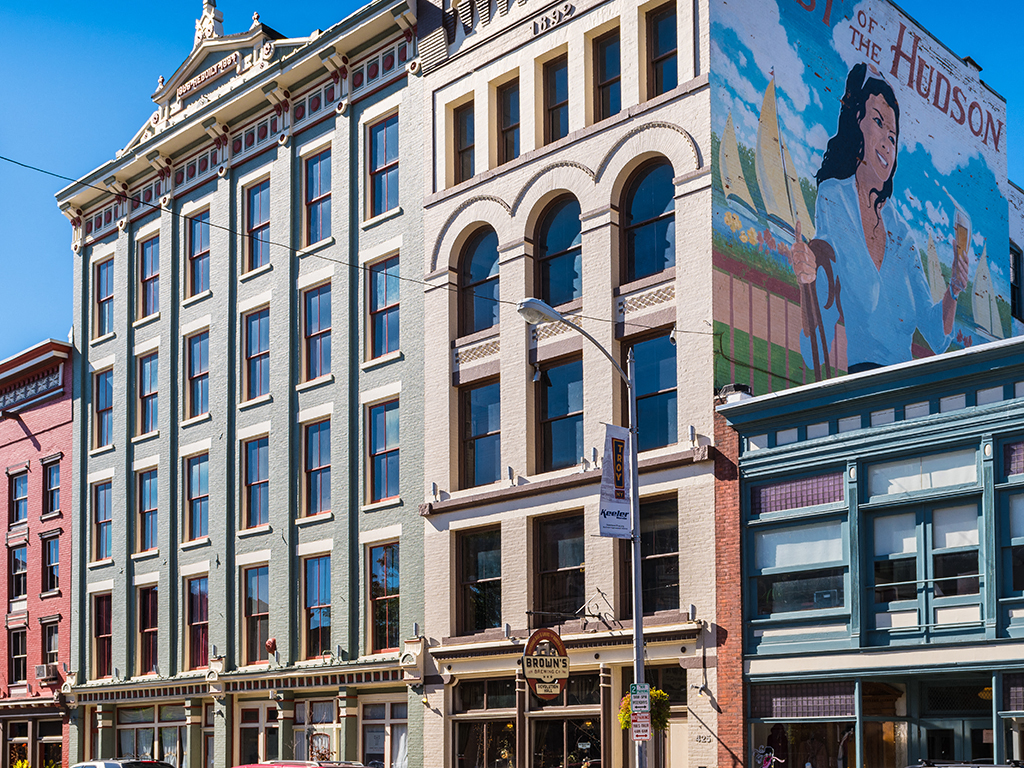 a tall building with a large mural on the side of it