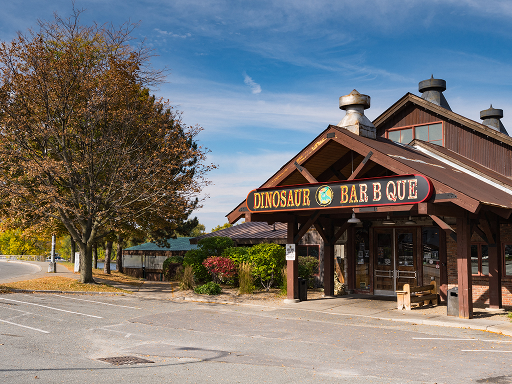 a restaurant on the side of a road with a tree