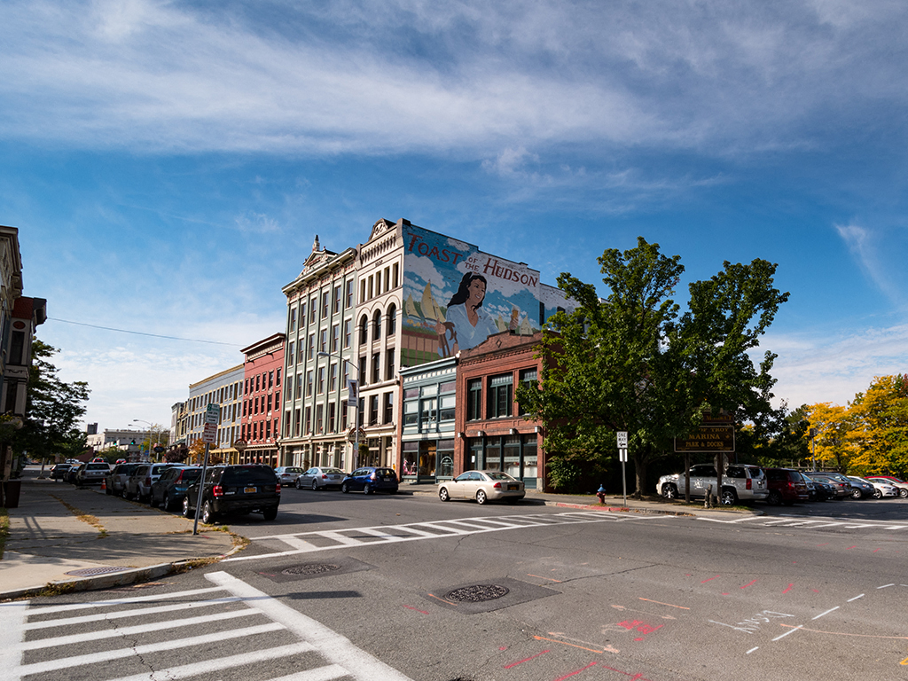 a mural on the side of a building on a city street
