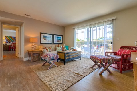 a living room with furniture and a sliding glass door