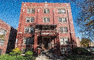 a picture of a brick building with a reflection of it
