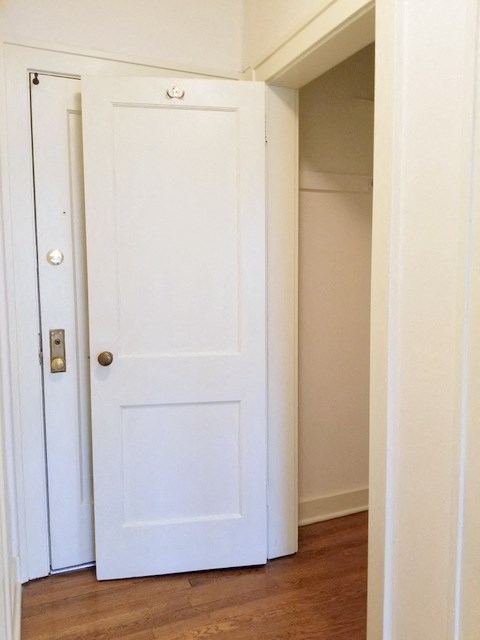 a white door in a room with a door open