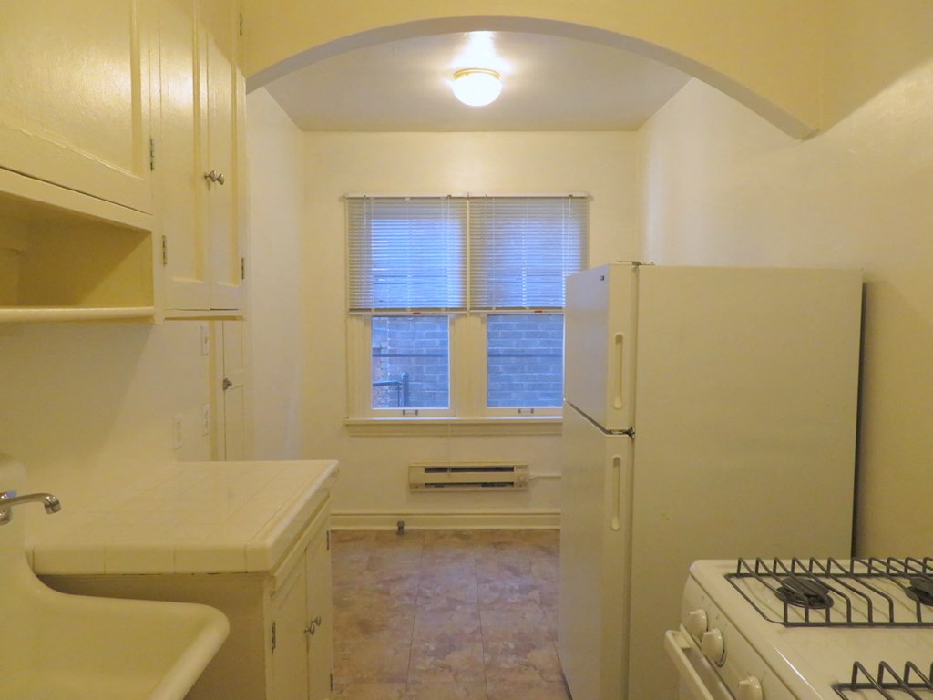 a kitchen with a refrigerator and a window
