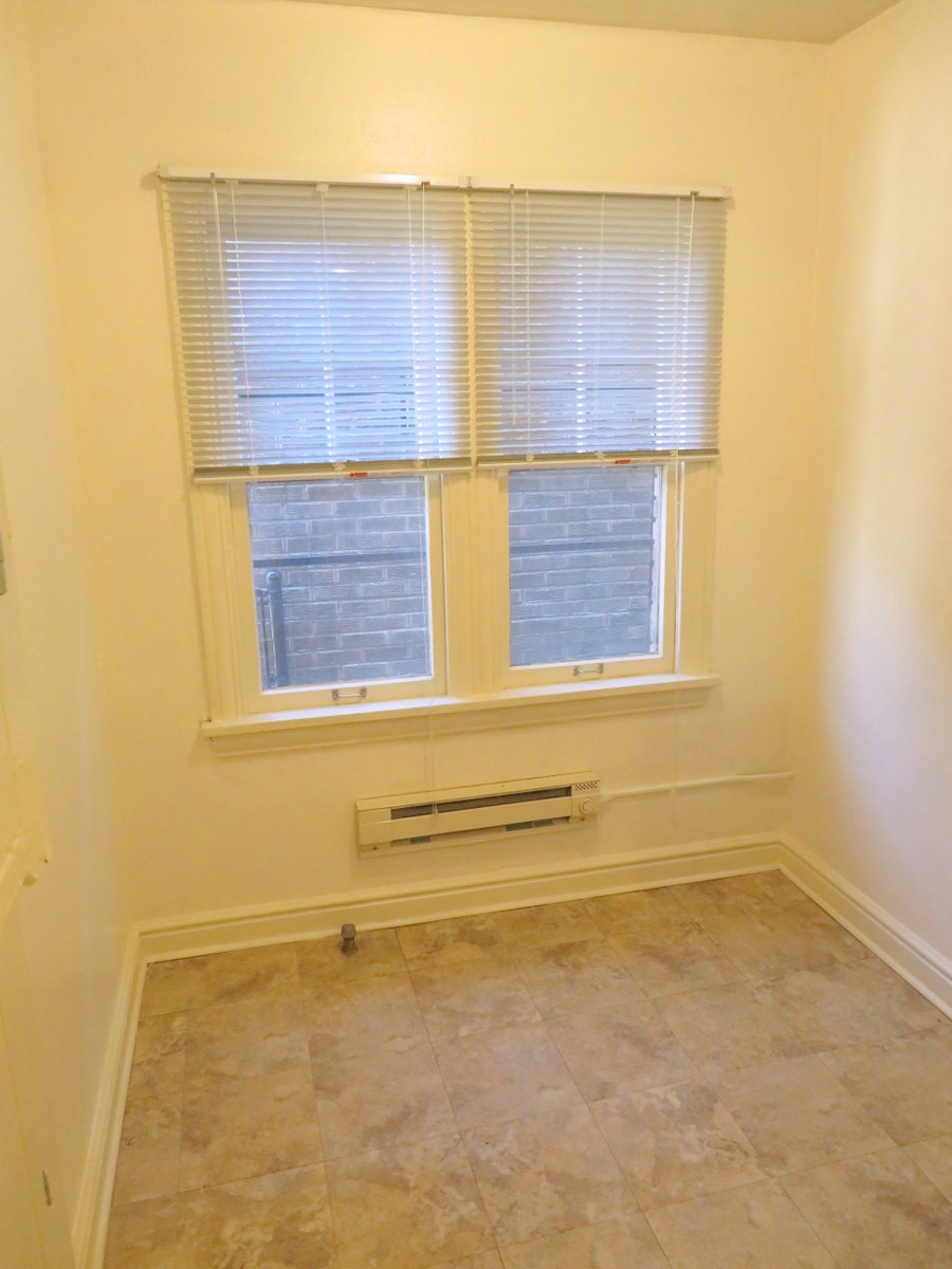 a small room with a radiator and a window