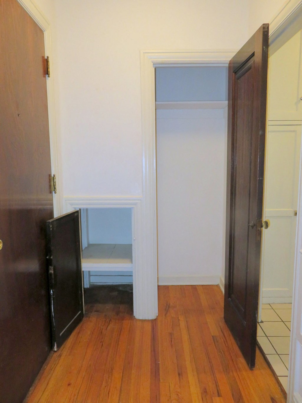 a room with a door to a closet and a chair in it
