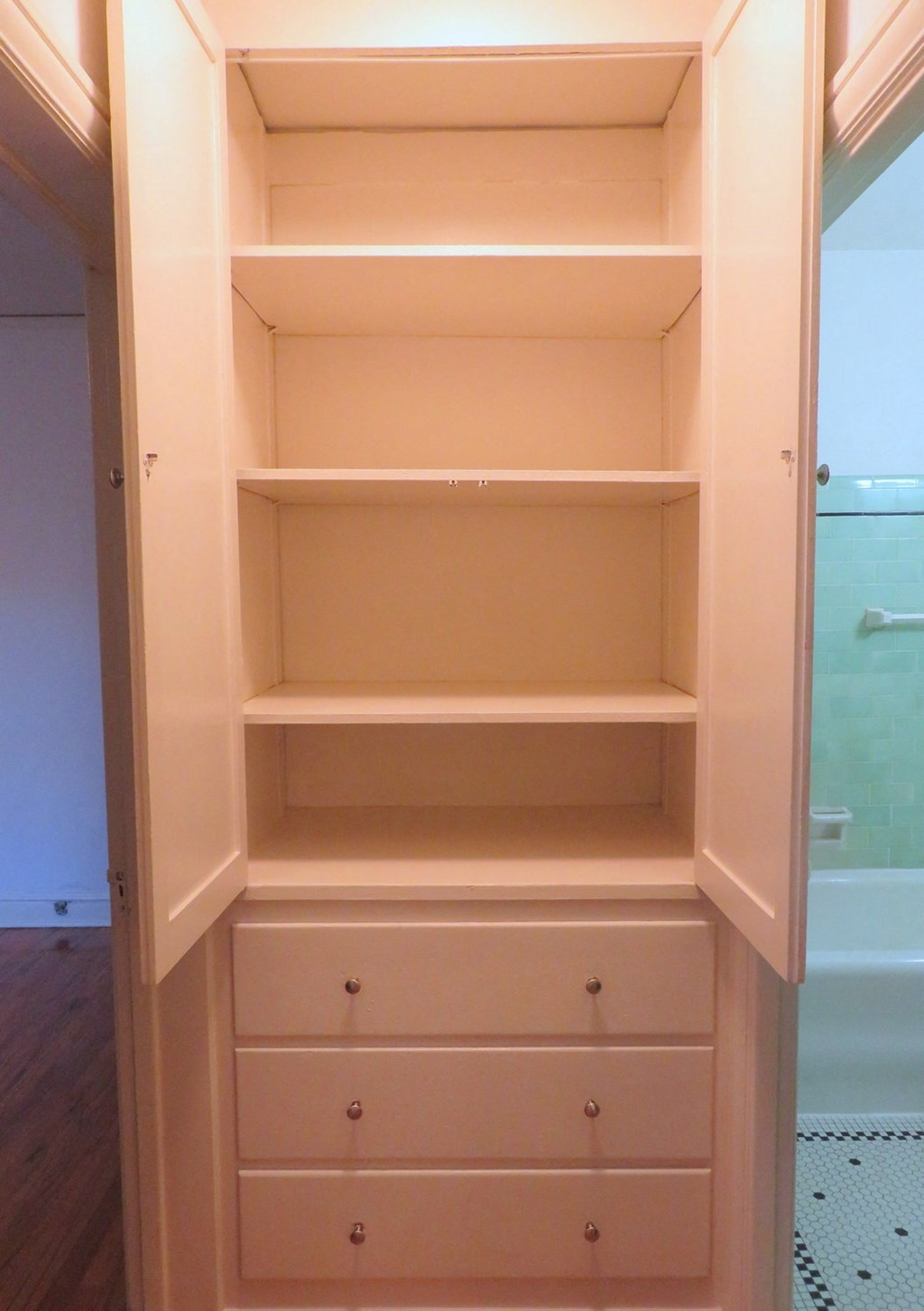 open shelving in a bathroom with a shower and