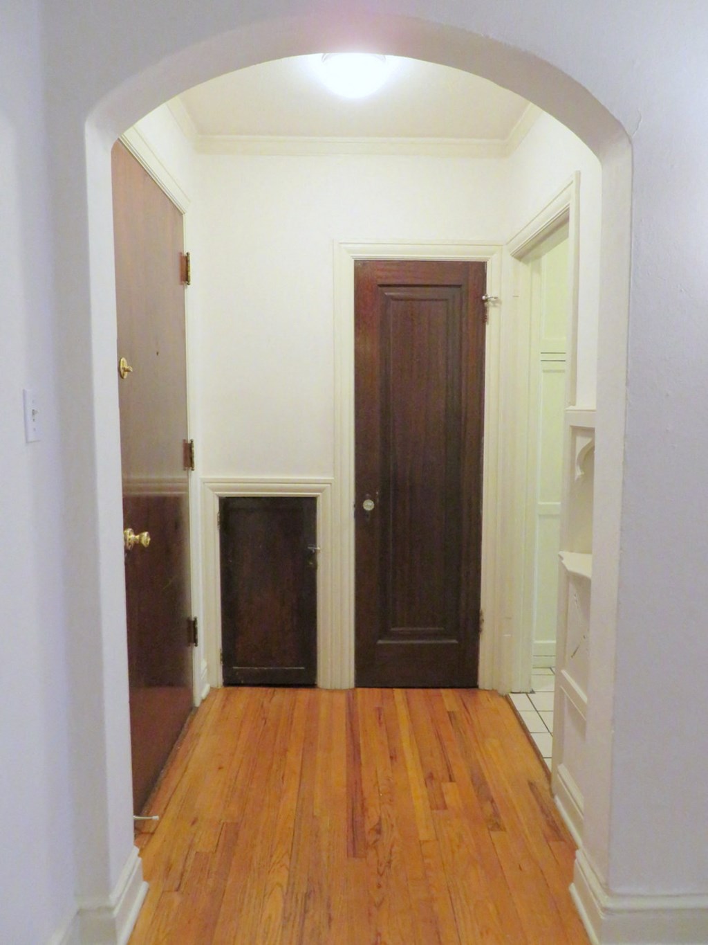 a room with a wooden floor and a wooden door
