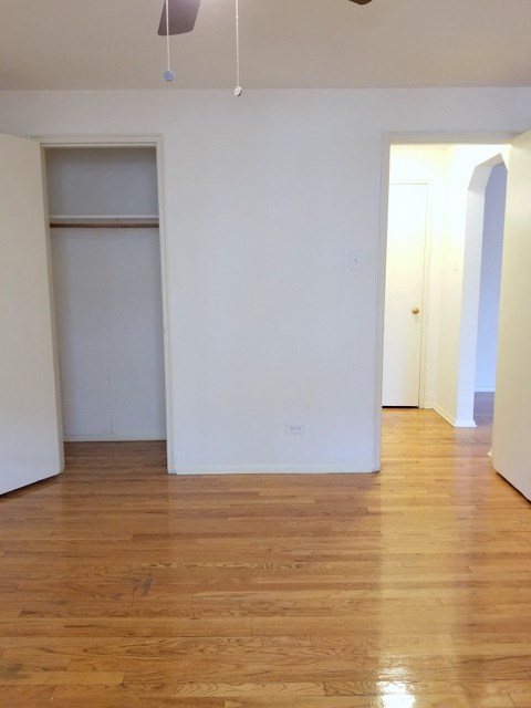 an empty living room with white walls and a closet