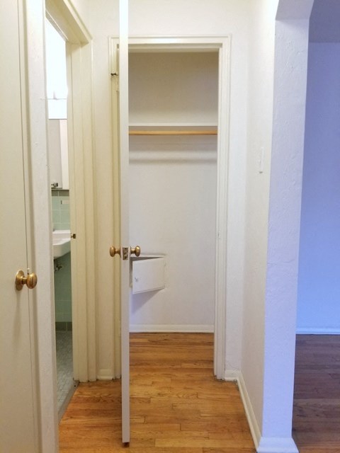 an empty closet in a room with a door open