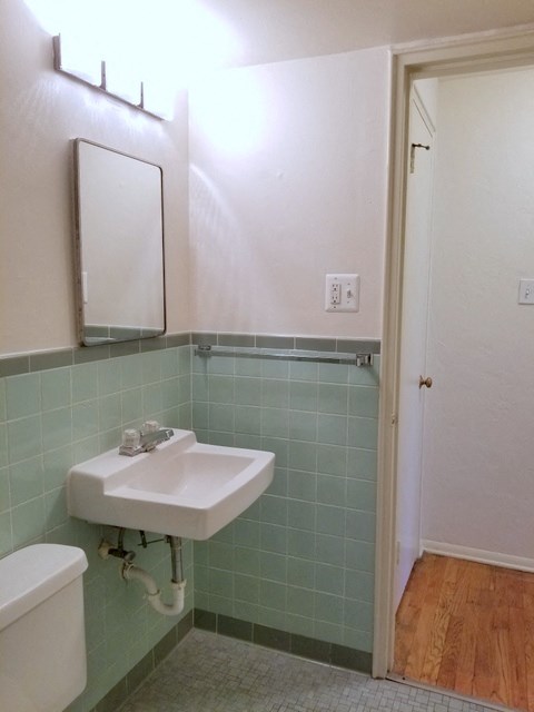 a bathroom with a sink and a mirror and a toilet