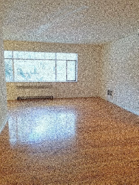 a large empty room with a window in it