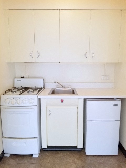 an old kitchen with white appliances and a sink