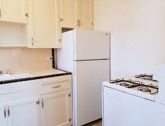 a kitchen with a stove and a refrigerator
