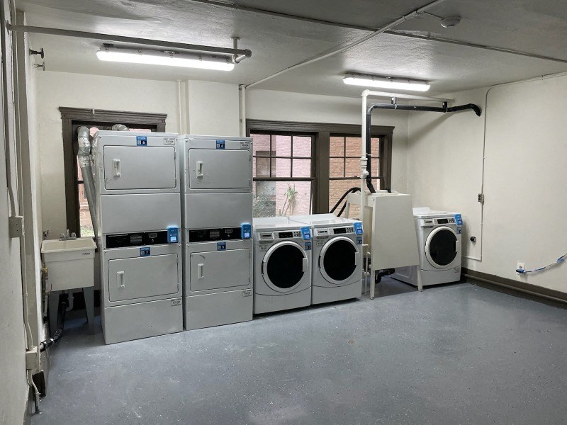 a group of washers and dryers in a room
