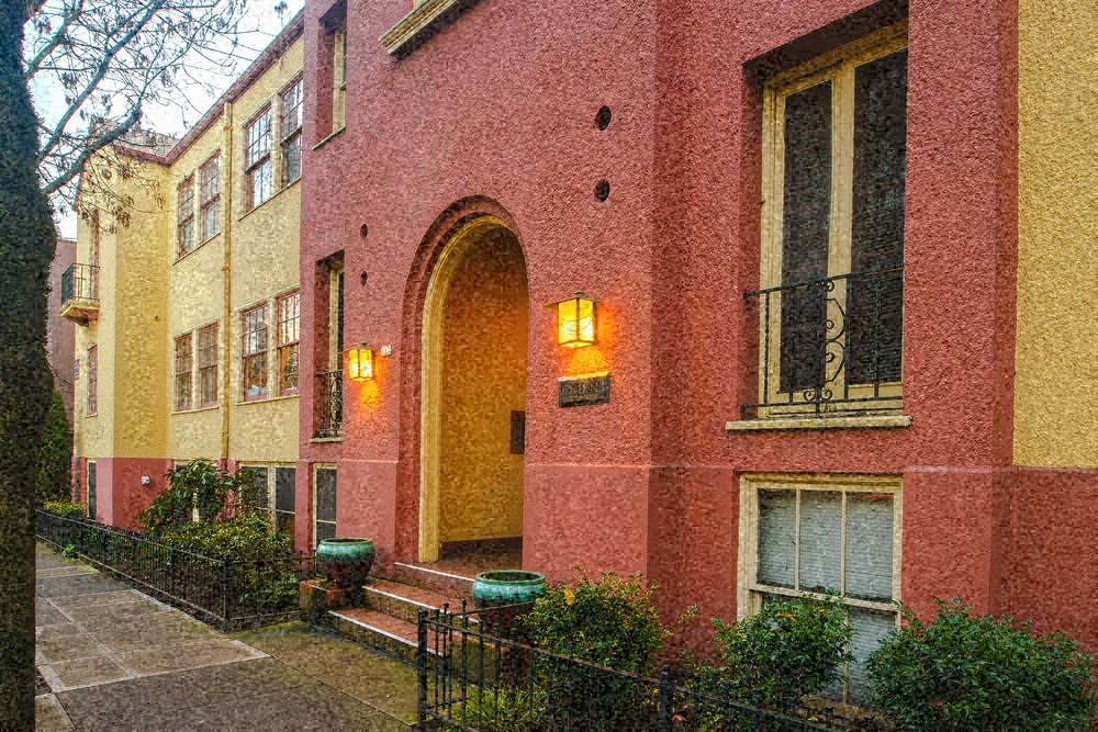 a brick building with a yellow and red facade