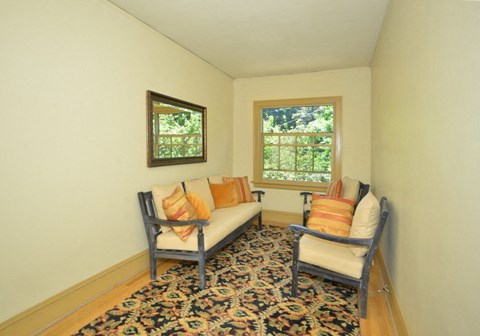 a living room with a couch and two chairs