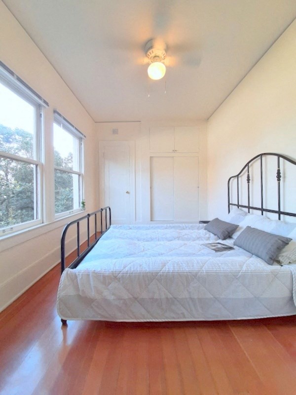 a bedroom with a large bed and a large window