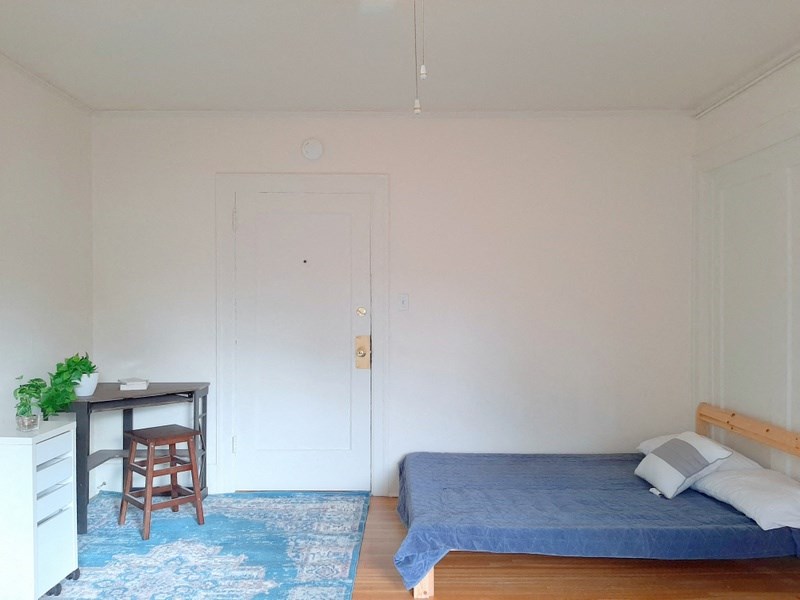 a small bedroom with a bed and a desk