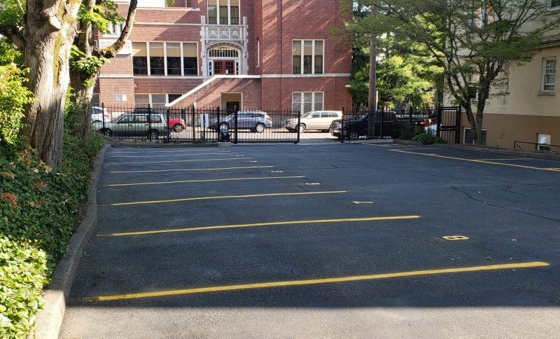 an empty parking lot in front of a brick building