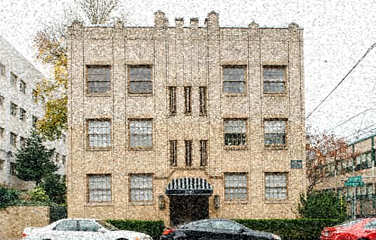 a tall building with cars parked in the snow