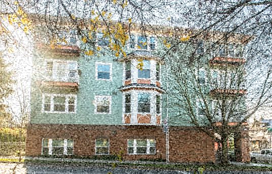 a reflection of a building in a window