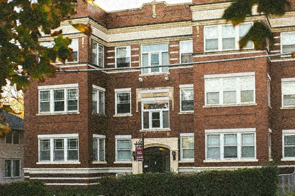 a red brick building with a black door