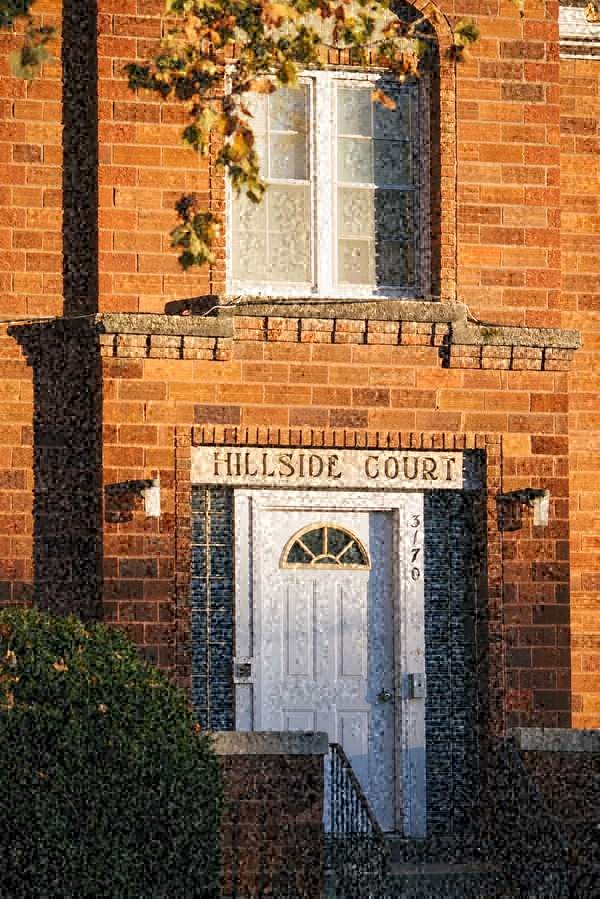 a brick building with a blue door and a window