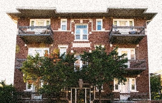 a red brick building with trees in front of it