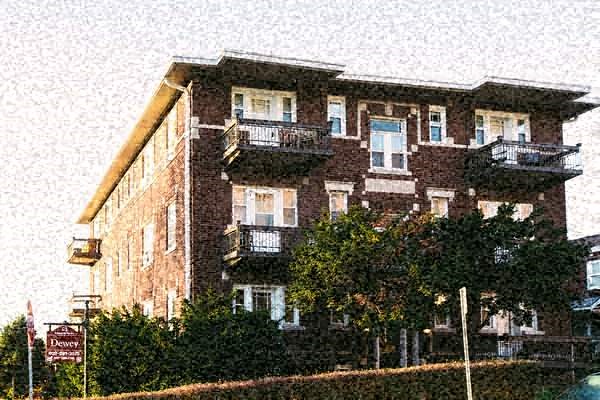 a large brick building with trees in front of it