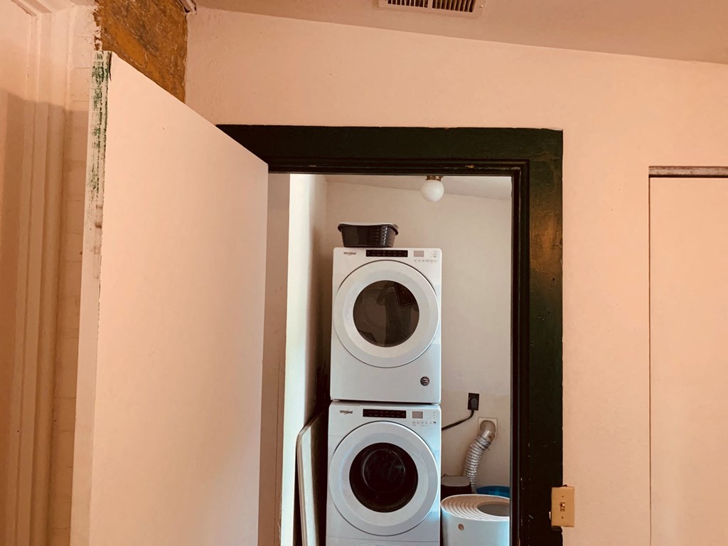 a washing machine and a dryer in a room