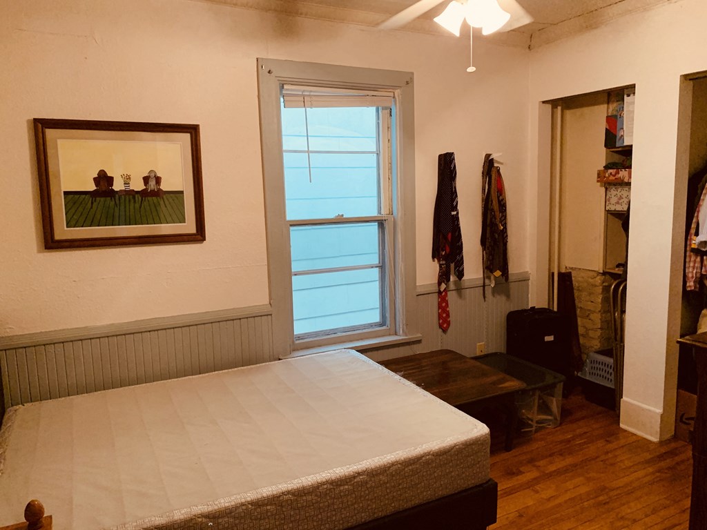 a bedroom with a bed and a window