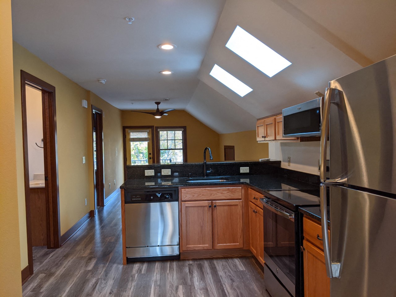 a kitchen with stainless steel appliances and wooden cabinets
