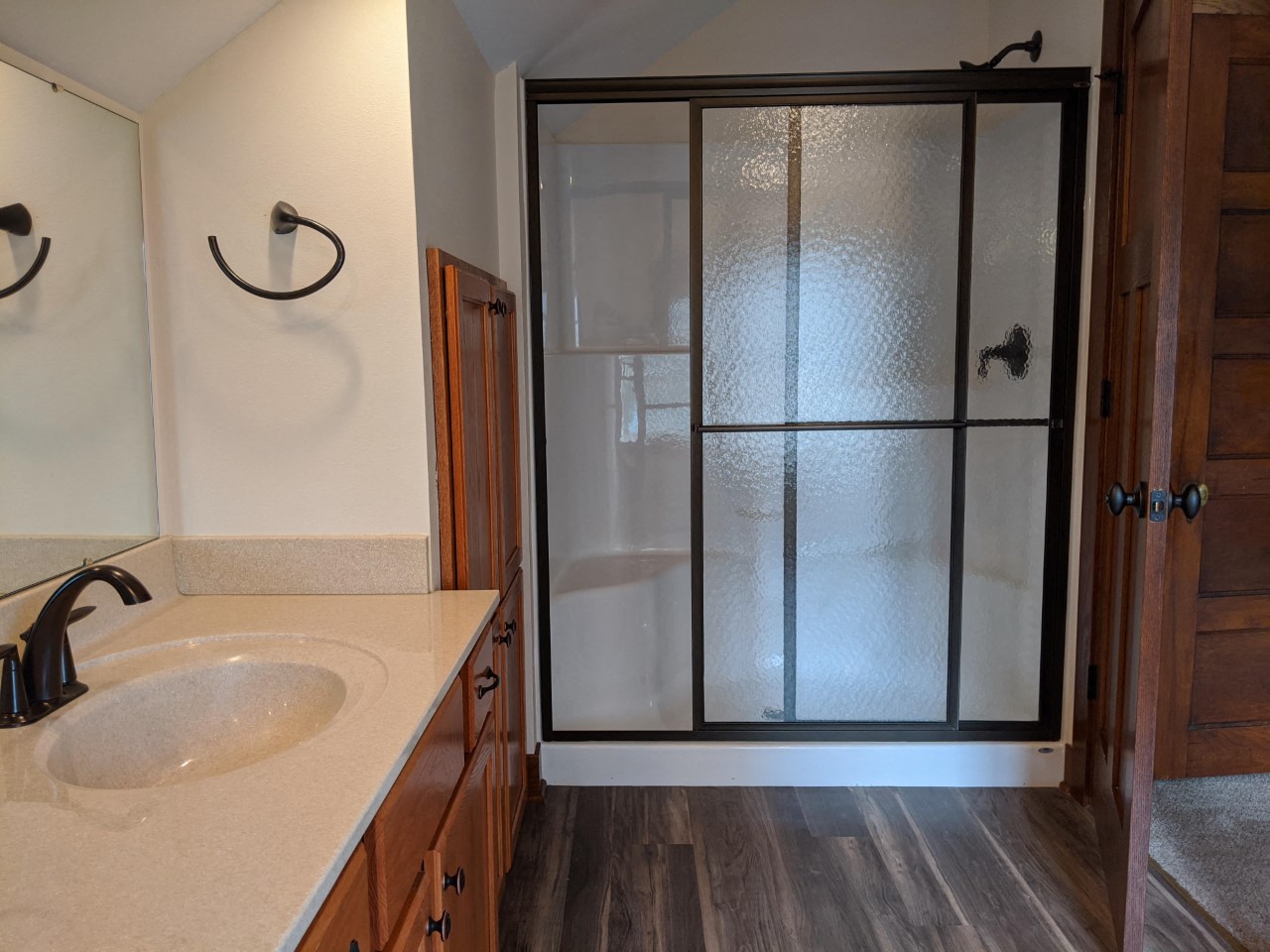 a bathroom with a shower and a sink