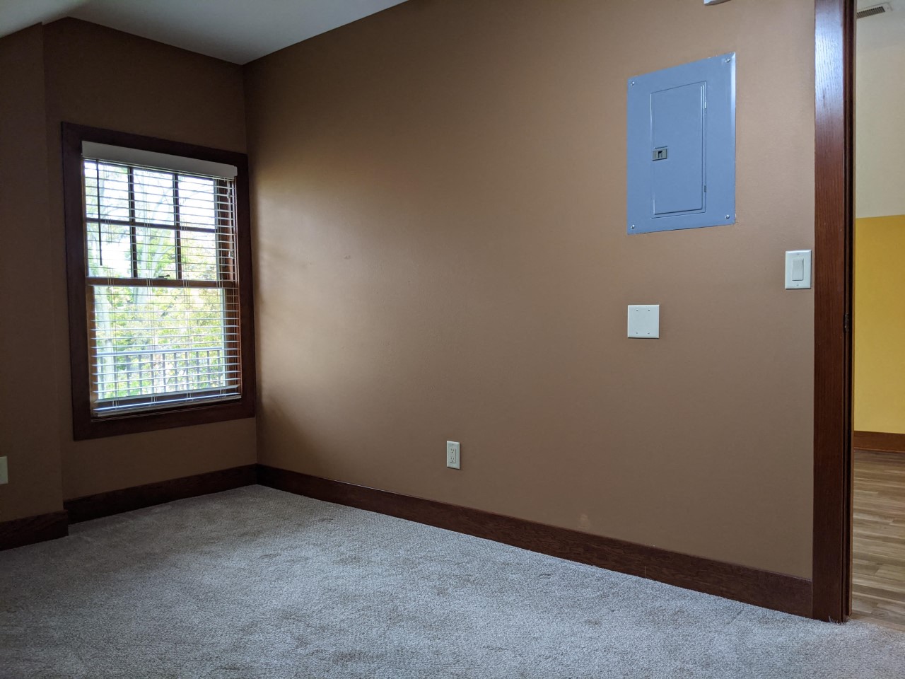 a empty room with a window and carpet
