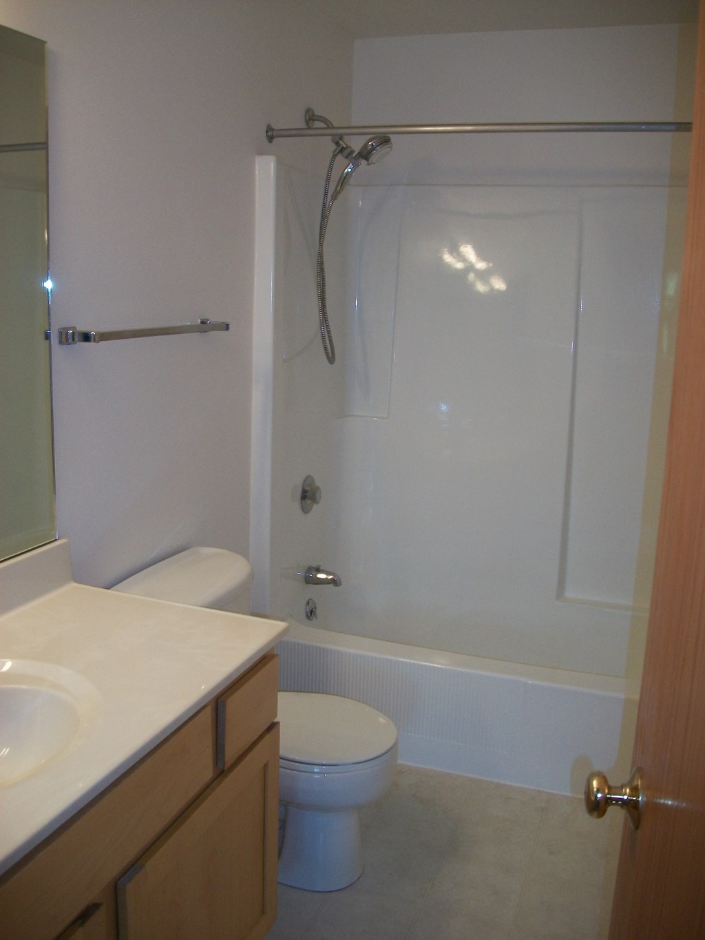 a small bathroom with a shower toilet and sink
