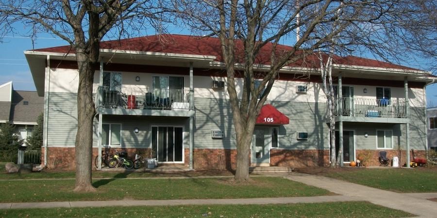 a white house with a red roof and some trees