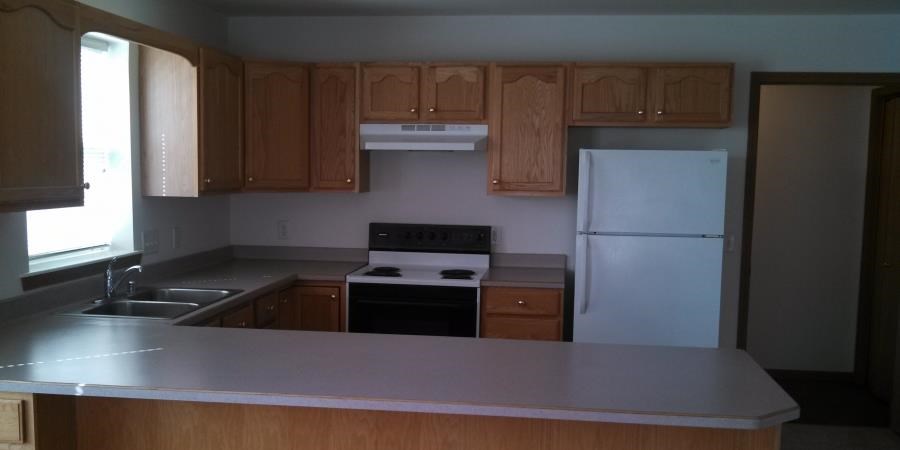 a kitchen with a stove and a refrigerator