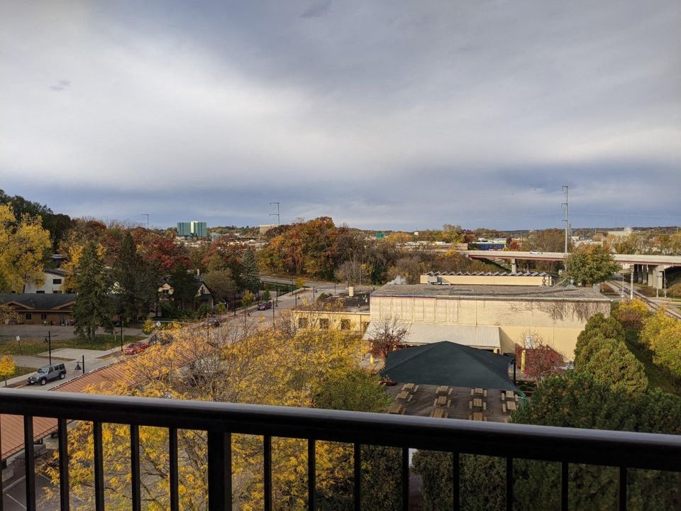 a balcony with a view of a city and a building