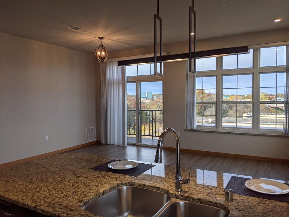 a kitchen with two sinks and a large window