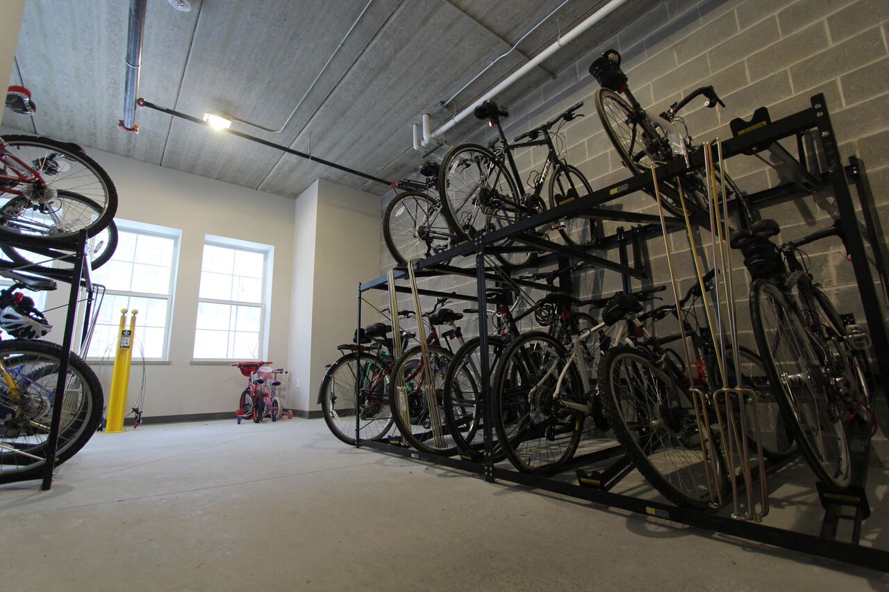 the bike rack in the garage is full of bikes