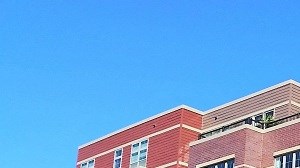 a large brick building with a car parked in front