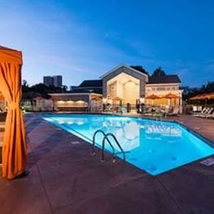 a swimming pool is lit up at night
