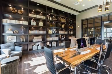 a conference room with a wooden desk and chairs