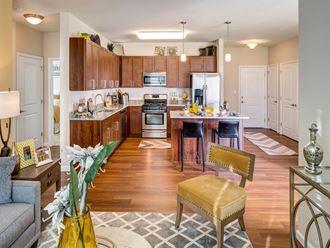 a kitchen and living room with wood flooring and