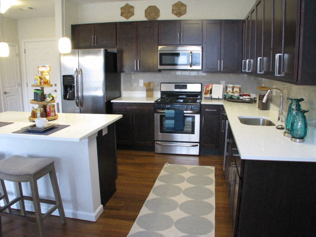 a kitchen with stainless steel appliances and a white counter top