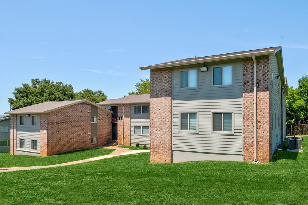 an apartment building with a brick building next to it